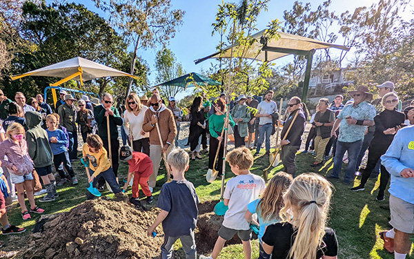 Children planting a tree in Bluebird Park