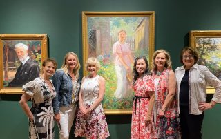 Board members posing in front of sponsored painting in Joeseph Kleitsch exhibit
