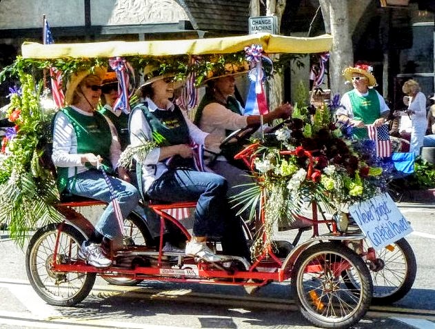 Members in decorated hats riding cart in the 2012 Patriot's Day Parade